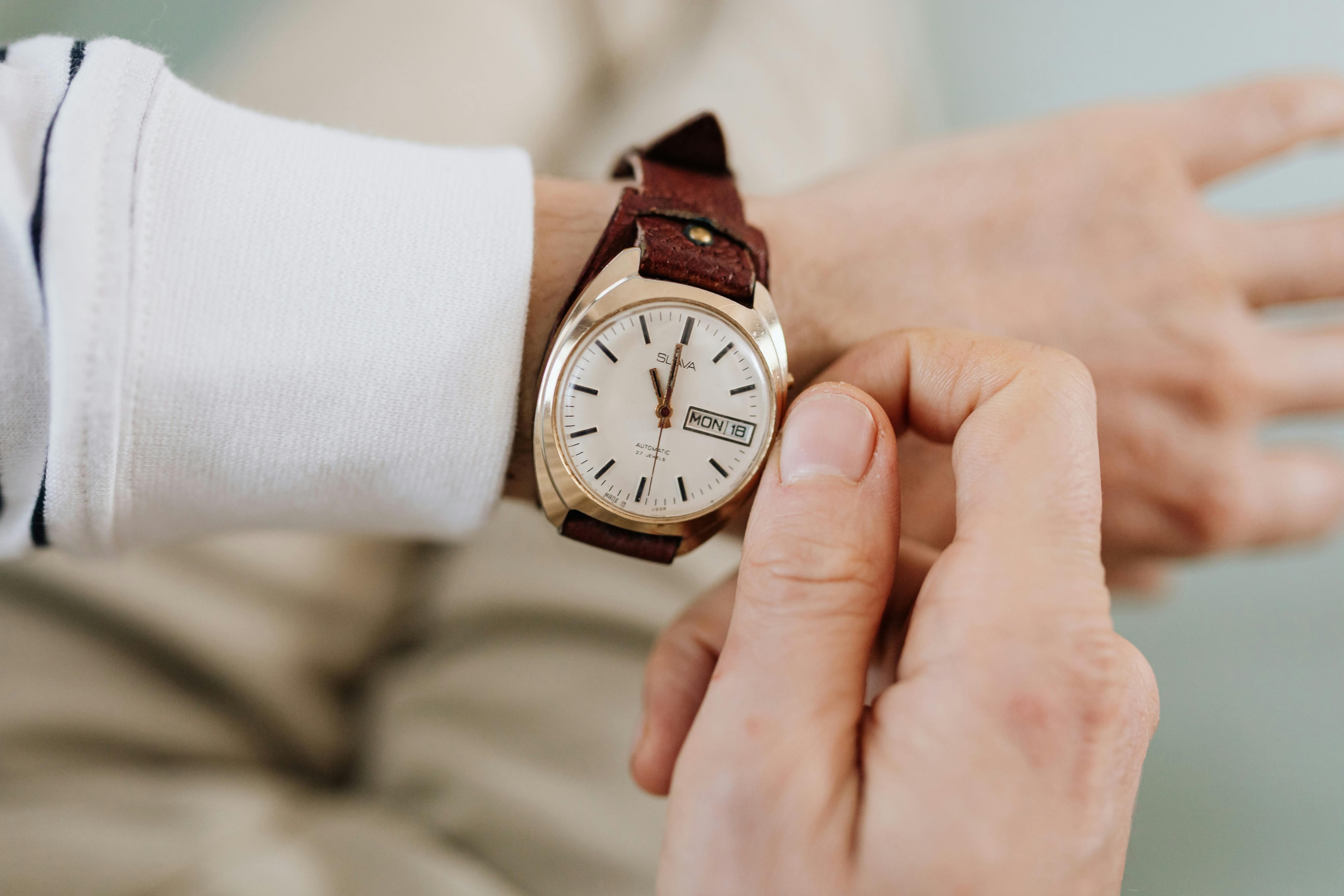 Real estate investor checking time on watch.