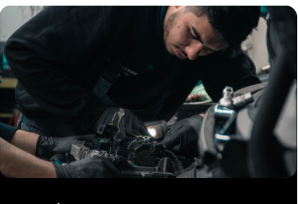 Mechanic working on inside of a vehicle