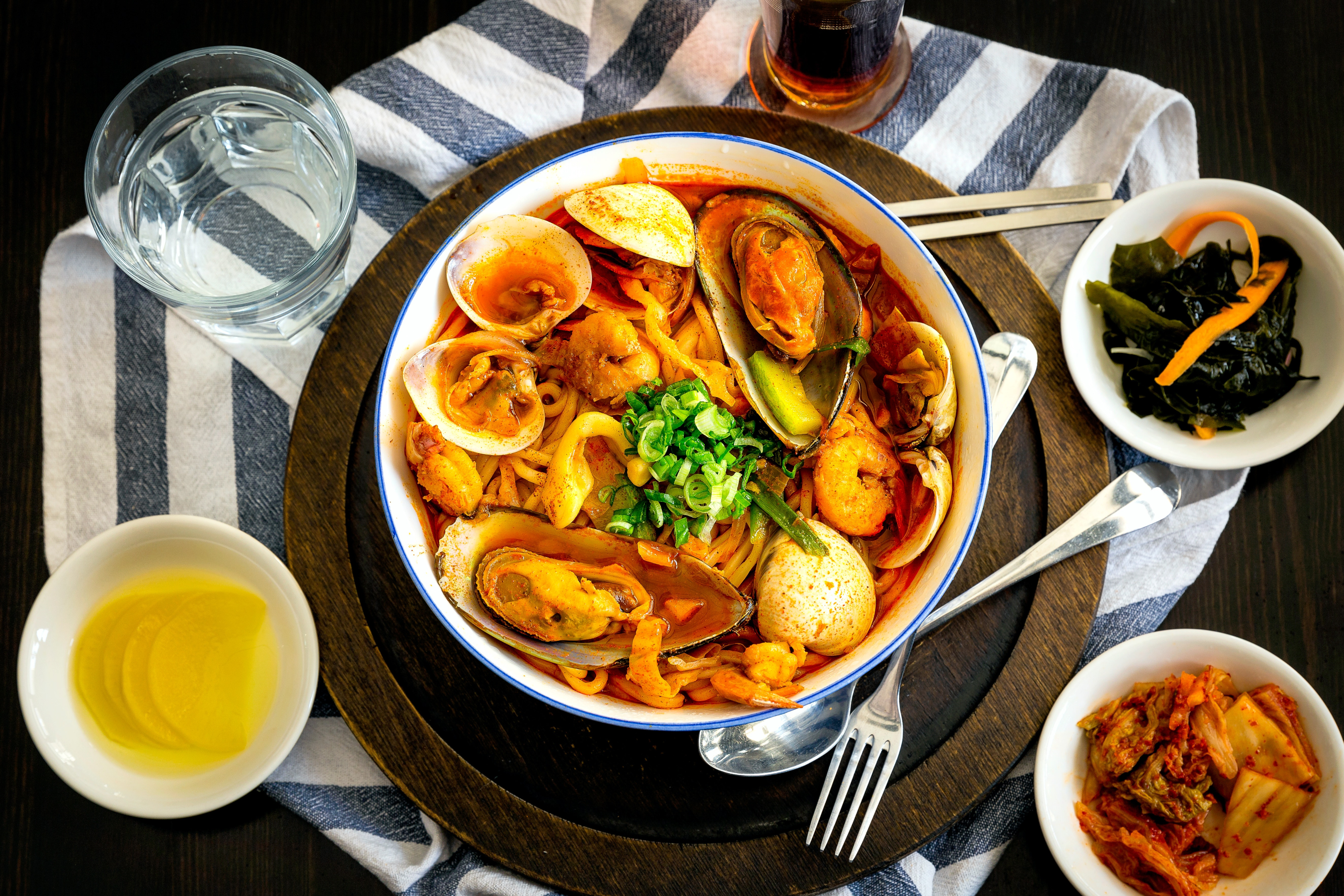 Image source: https://www.pexels.com/photo/seafood-delicacy-on-bowl-near-gray-stainless-steel-fork-spoon-chopsticks-beside-water-in-drinking-glass-on-table-2313682/     Caption: Seafood pasta dish