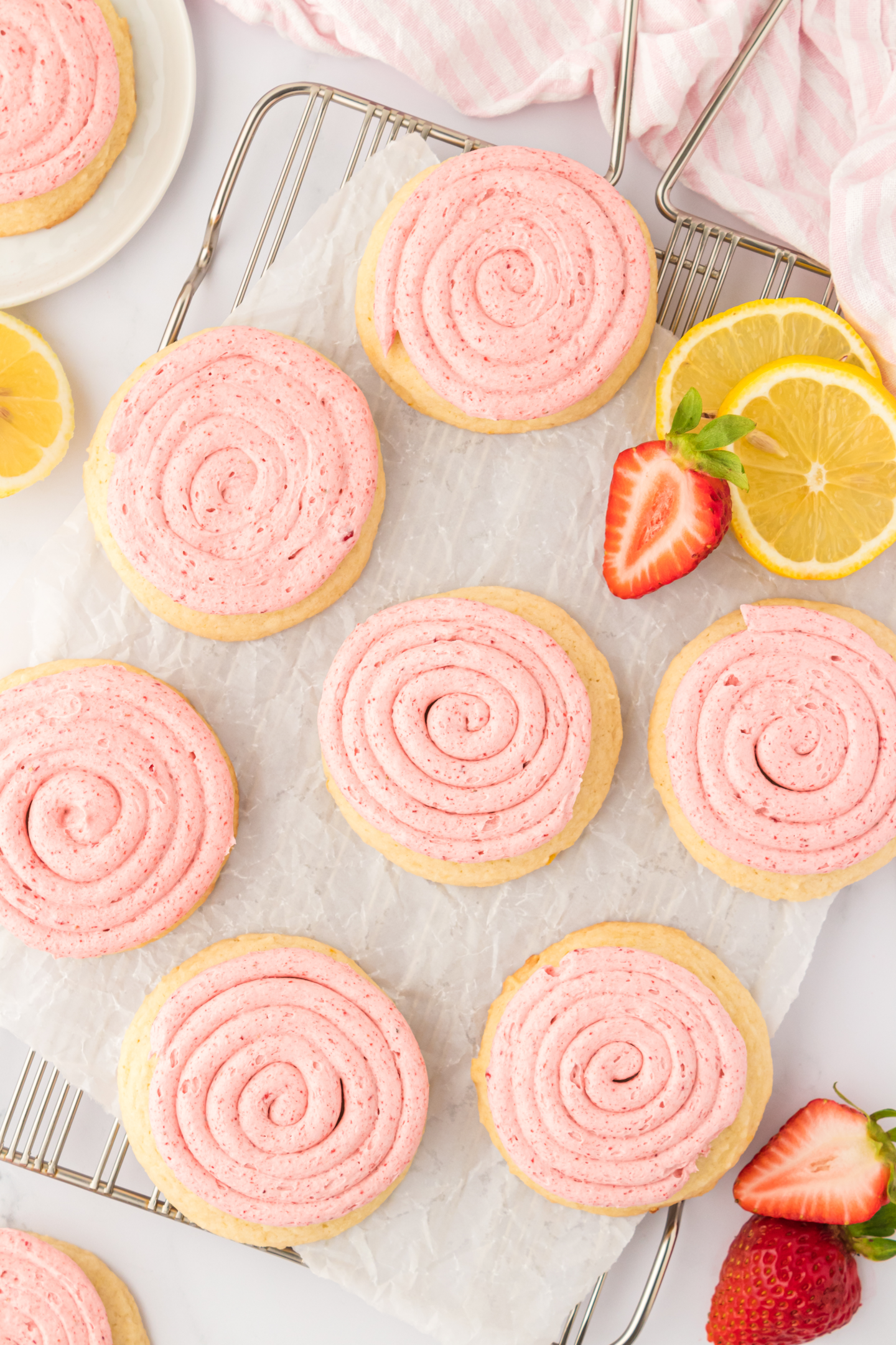 frosted strawberry lemonade cookies on a cooling ack