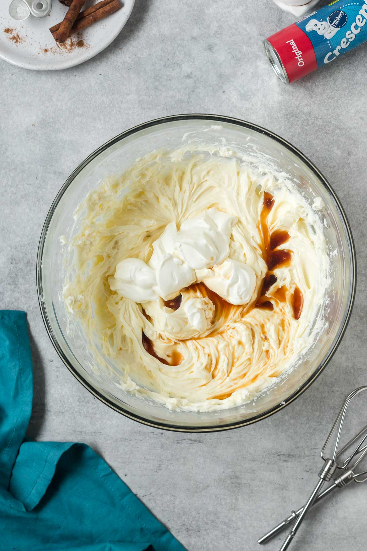 sour cream and vanilla added to cheesecake batter in bowl