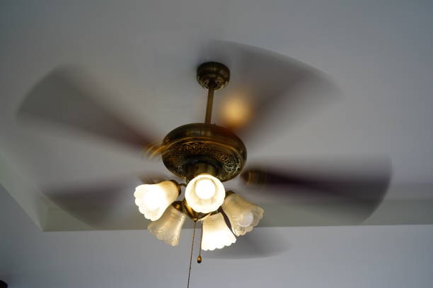 A ceiling fan rotating counterclockwise. 