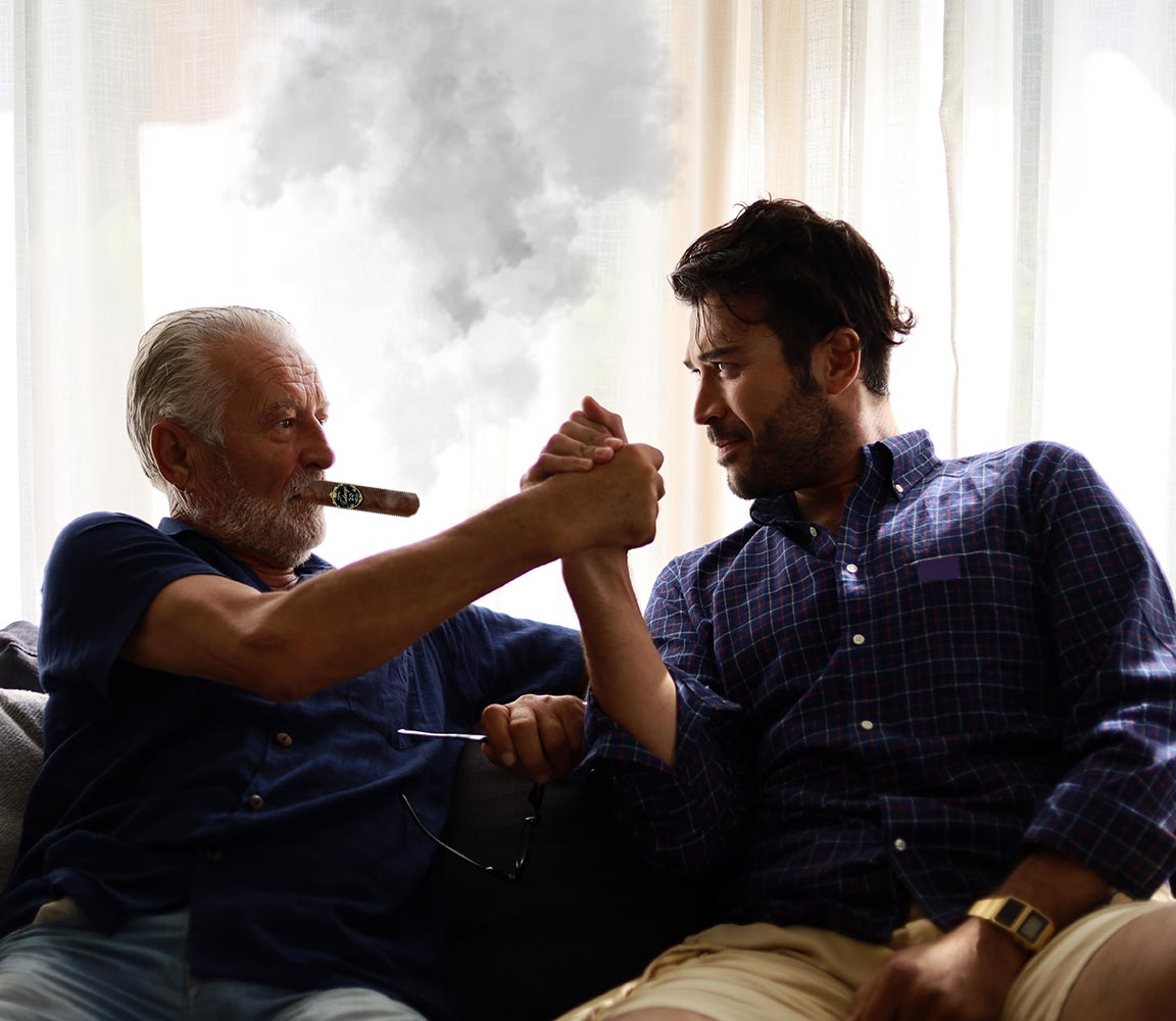 A father and son smoking Tatuaje cigars to celebrate the 20th anniversary