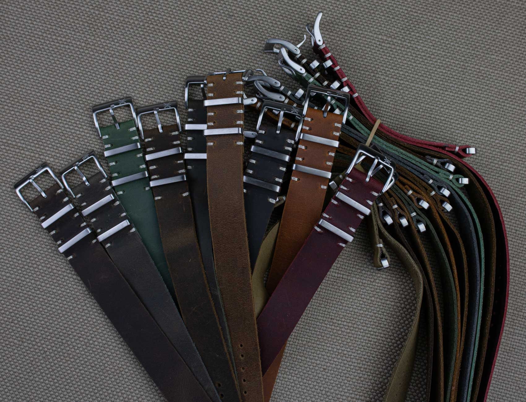 Quick-release leather watch straps in red arranged neatly.