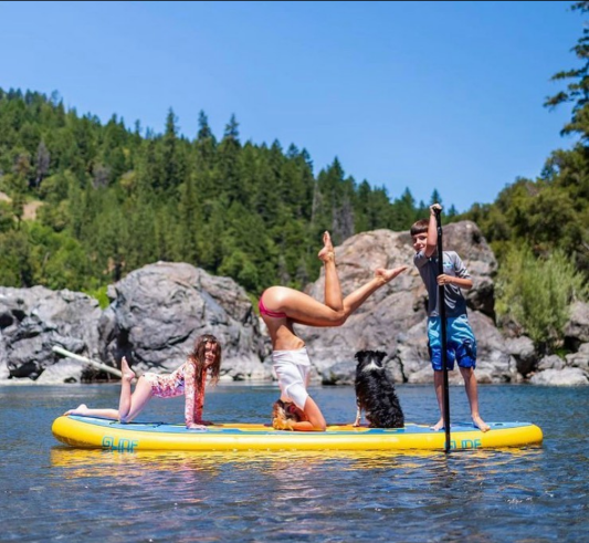 family and a dog on a paddle board