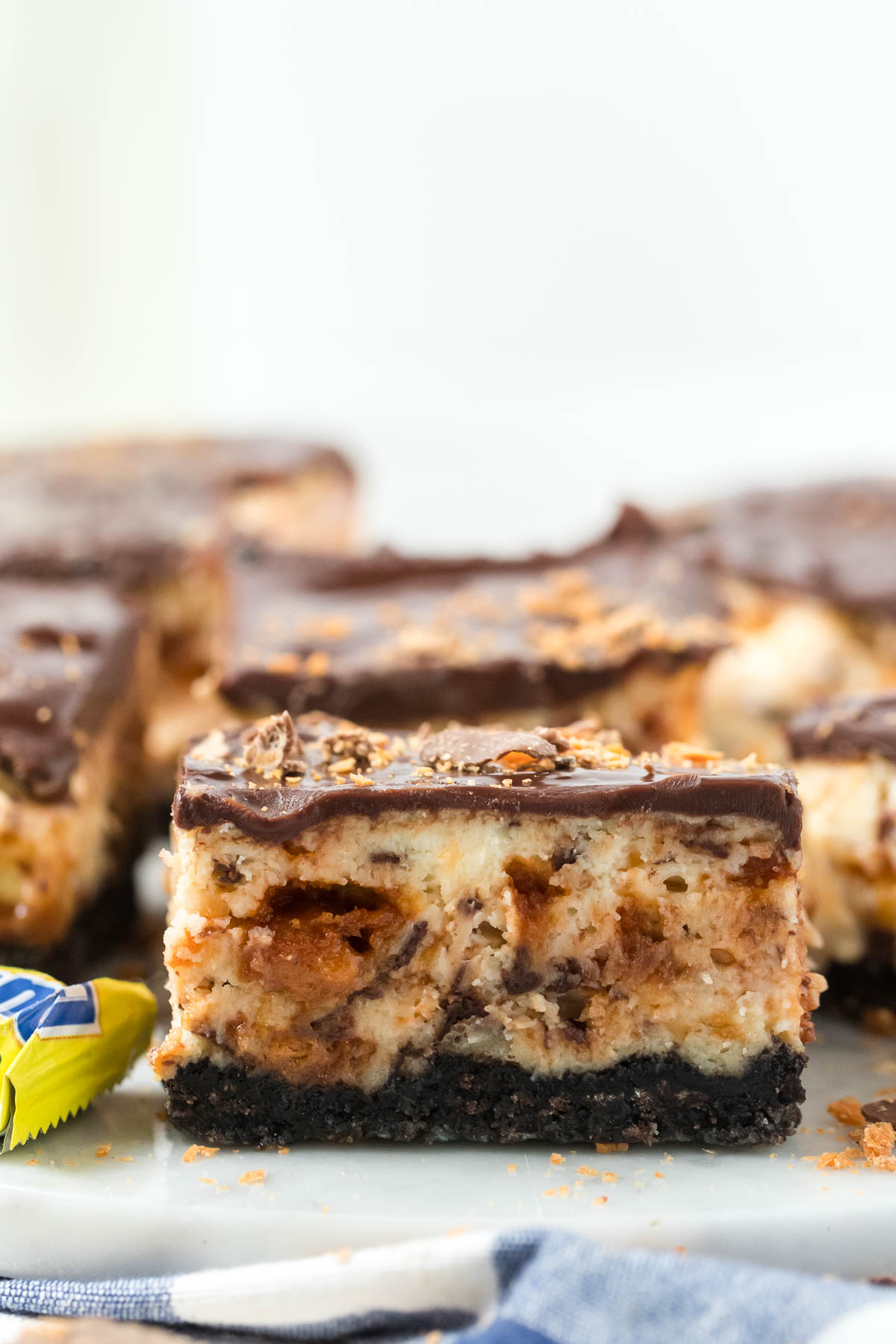 butterfinger cheesecake bar on marble board