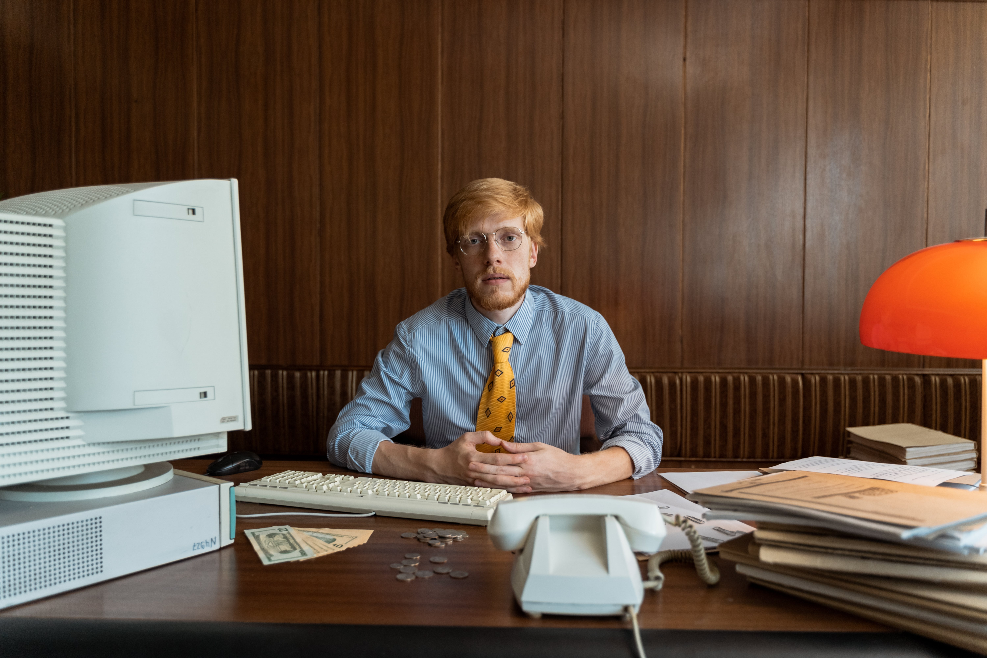 Accountant Sitting At Desk Looking Straight Ahead