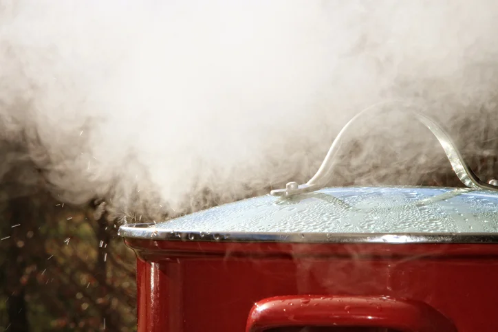 A pressure cooker releasing steam