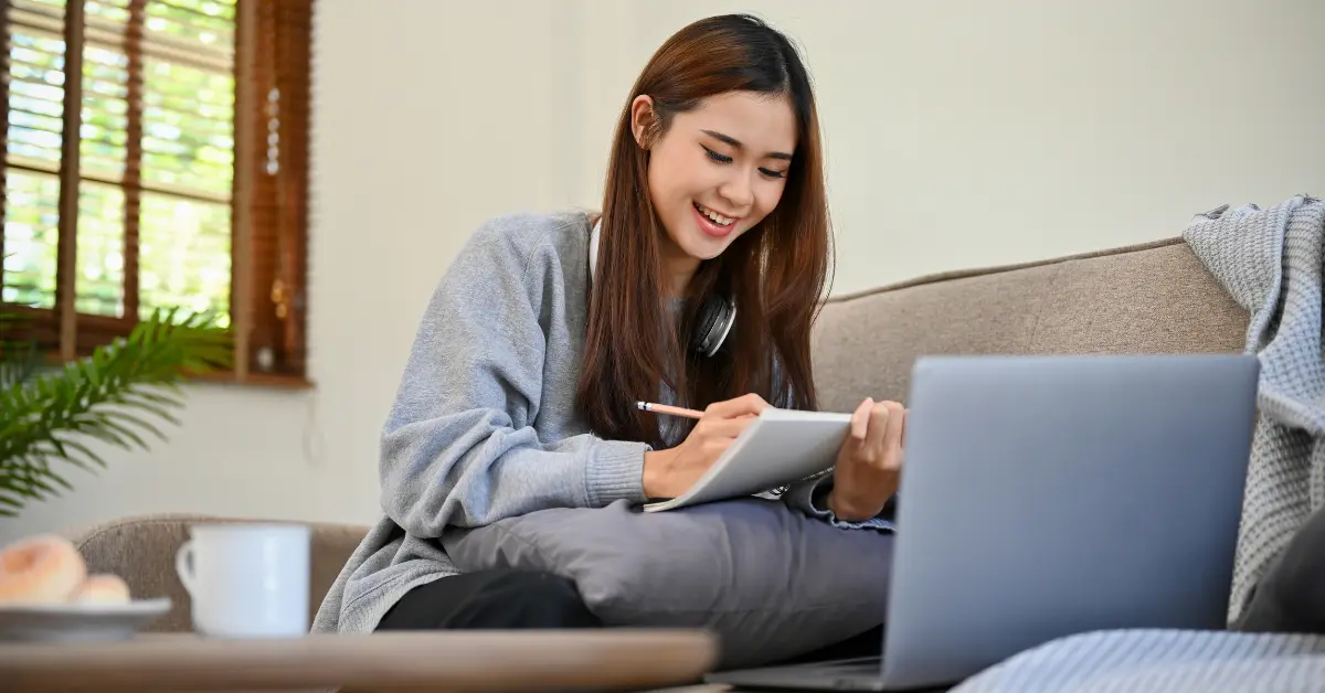 Woman reviewing tax documents and learning what is a Schedule K-1 for OnlyFans income reporting.