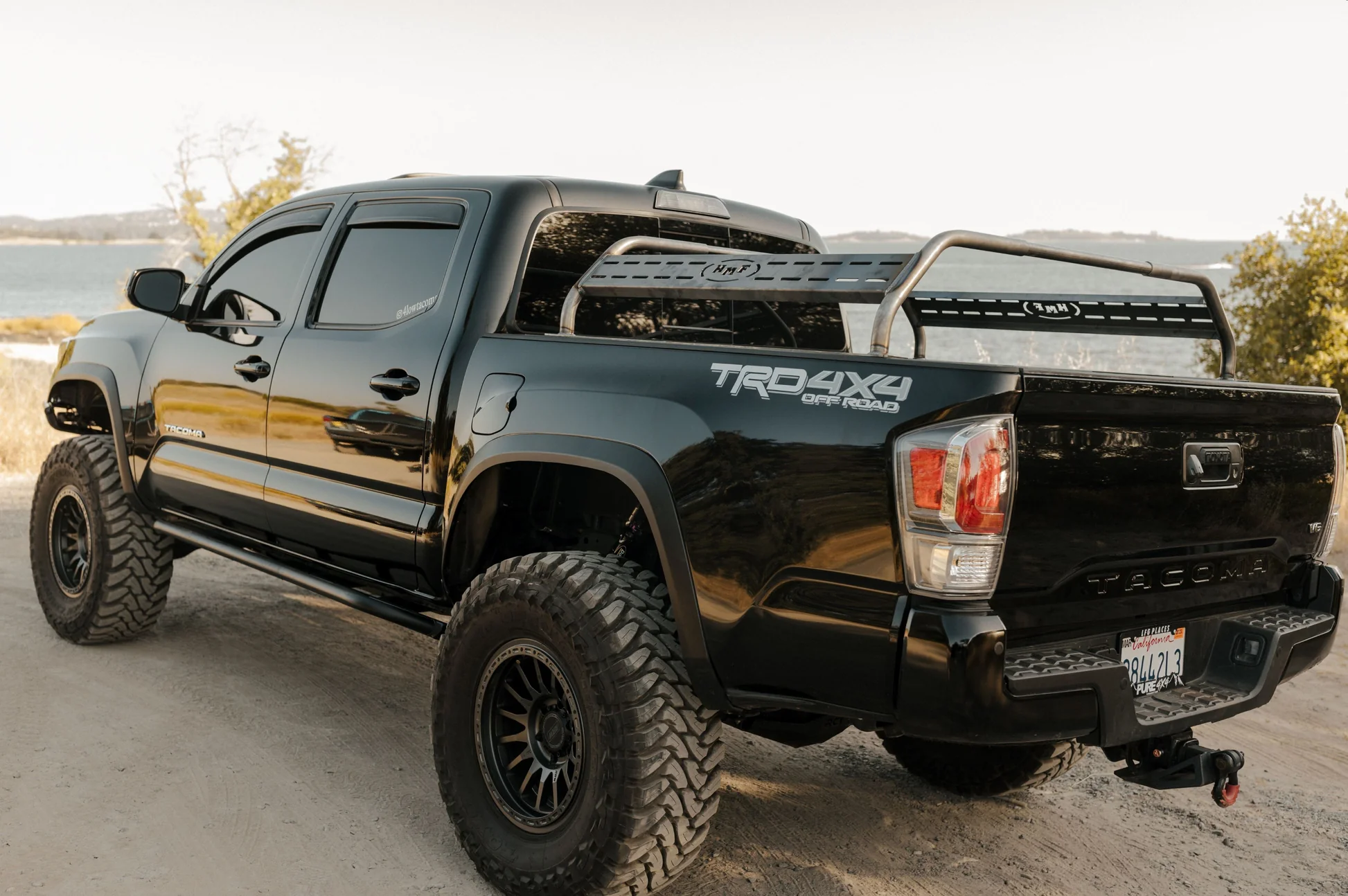 A black finish bed rack mounted on a Toyota Tacoma truck bed