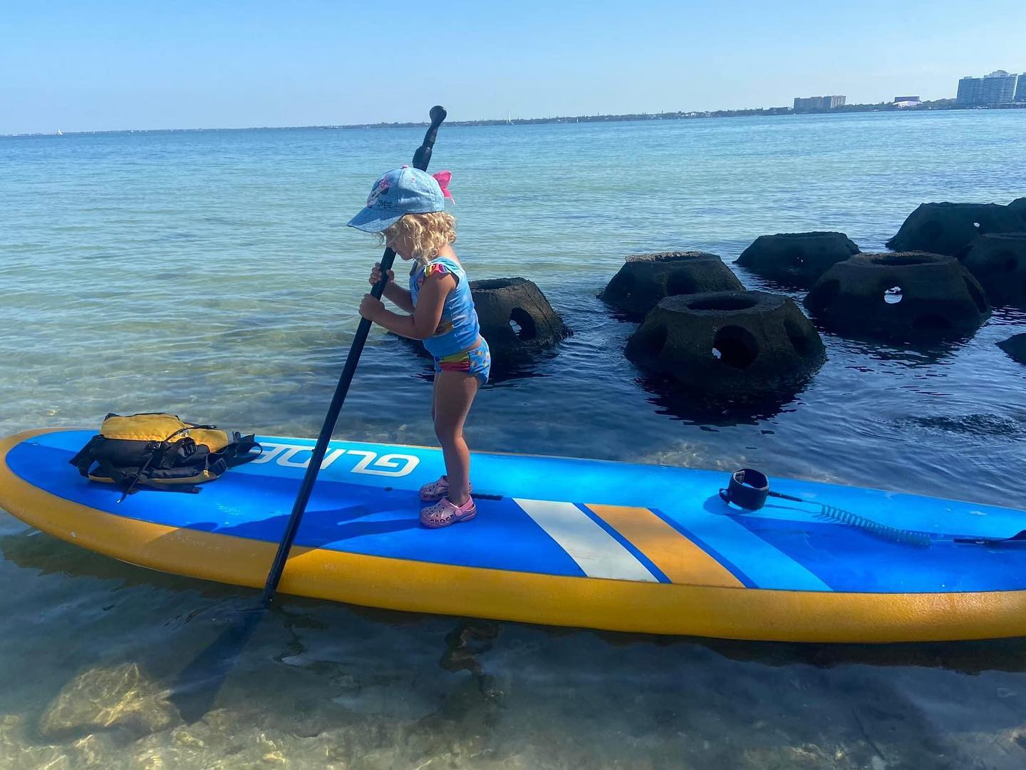child on a stand up paddle board