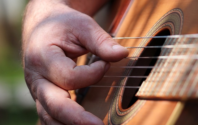 man, hand, guitar