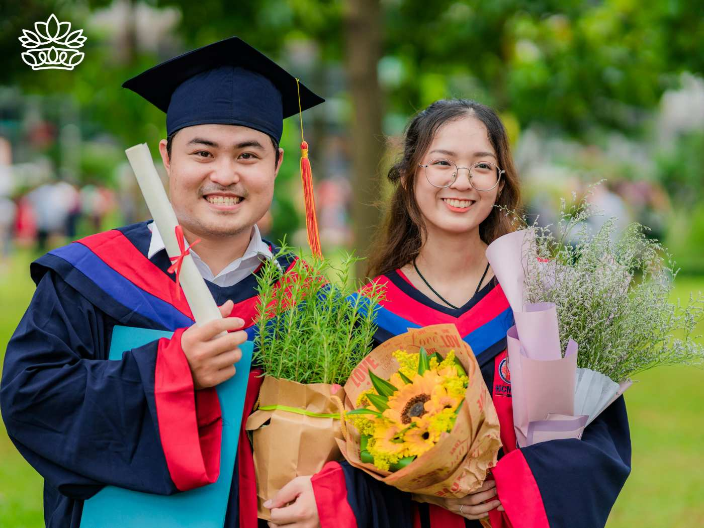 Cheerful male and female graduates holding diplomas and vibrant flower bouquets, celebrating their graduation day together outdoors. Graduation Flowers Delivered with Heart by Fabulous Flowers and Gifts.