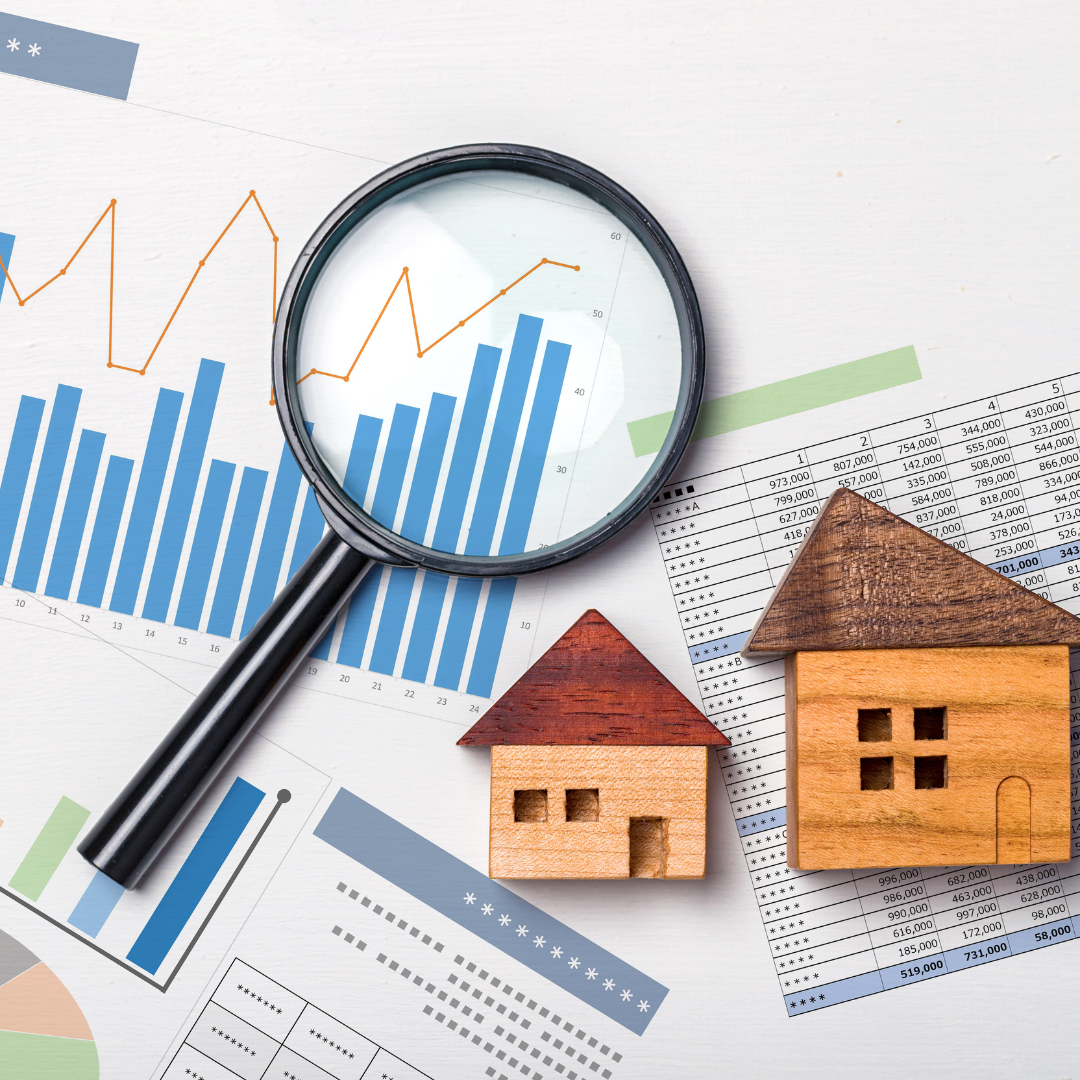 picture of graphs, magnifying glass, and wooden houses