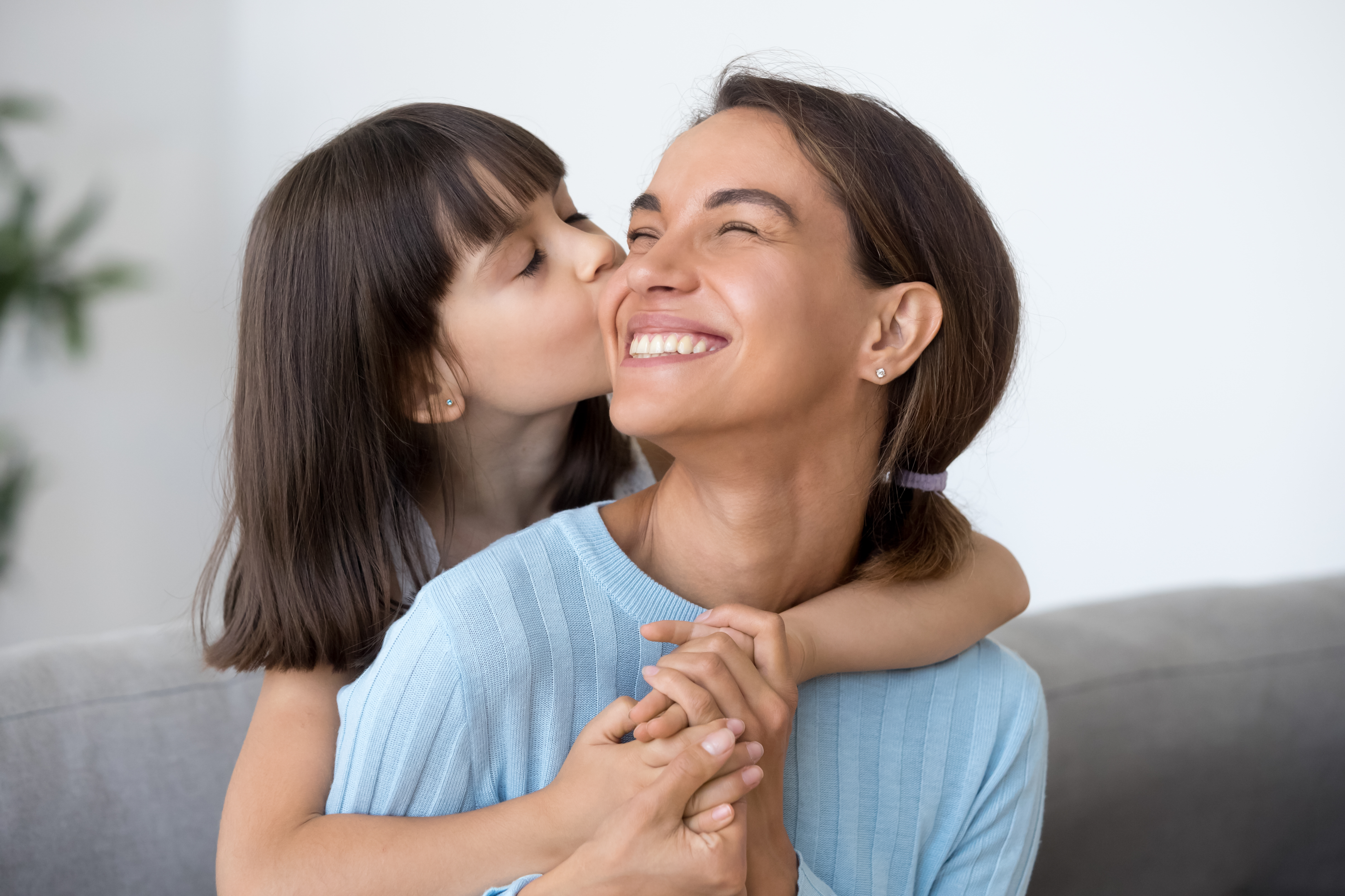 Daughter Kisses Happy Mom