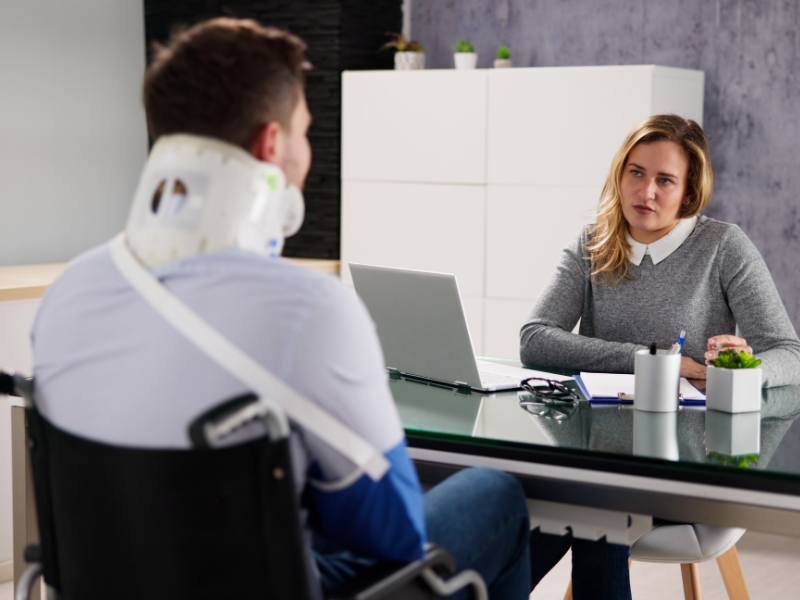 An image of a person talking to a lawyer to know what steps to take after a truck accident in Gadsden, AL.