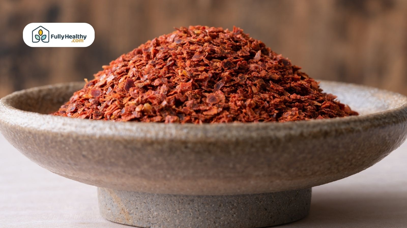 Stone bowl filled with coarsely ground Aleppo pepper