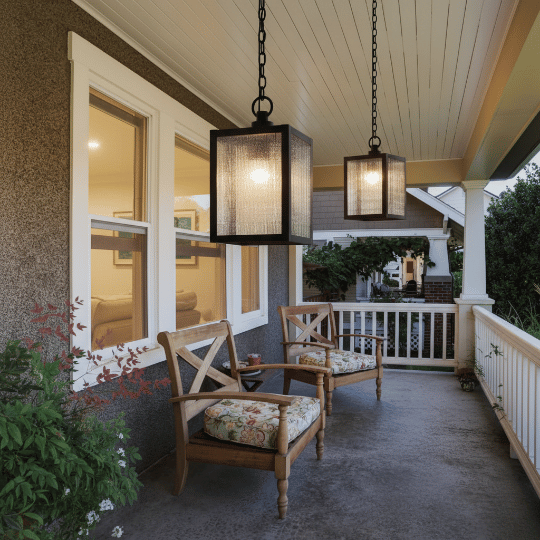 Hanging outdoor pendant light fixtures above covered deck seating.