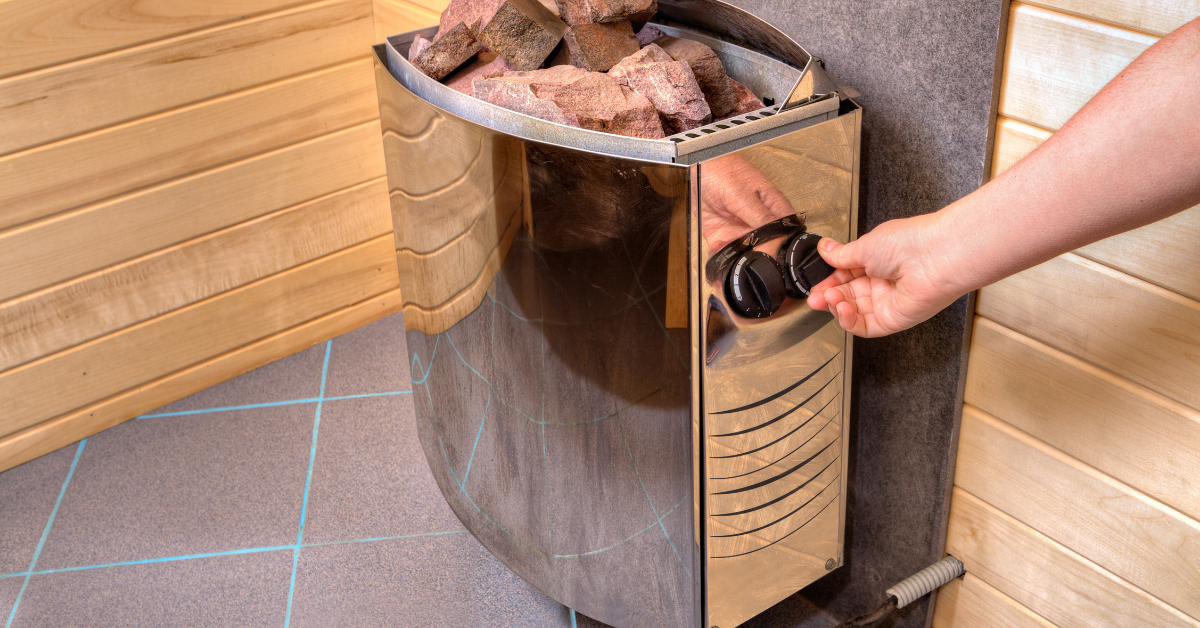 An image of a sauna heater being turned on with hot sauna rocks.