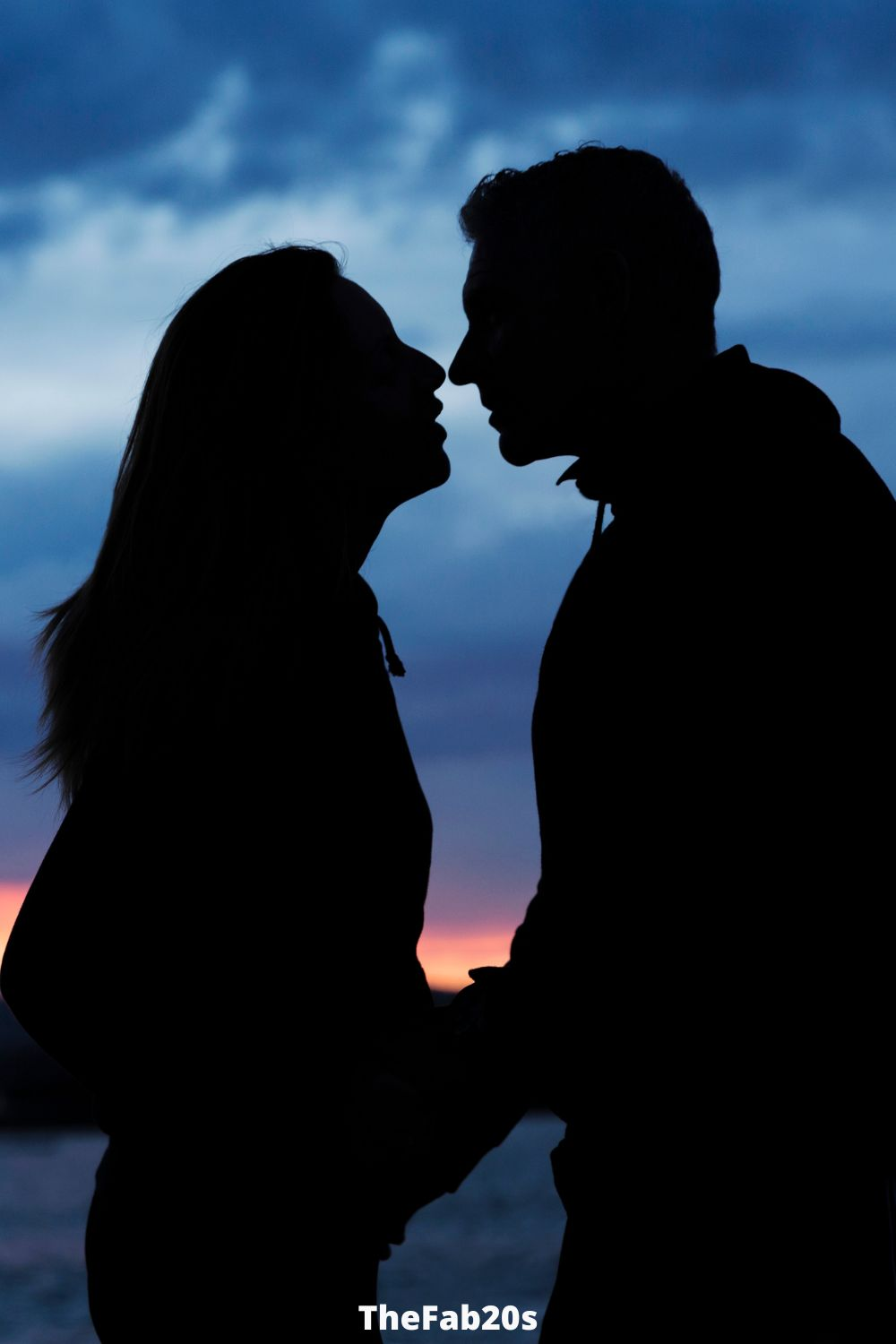 Couple Kissing At A Sunset - Featured In Signs A Guy Is Really Turned On By You