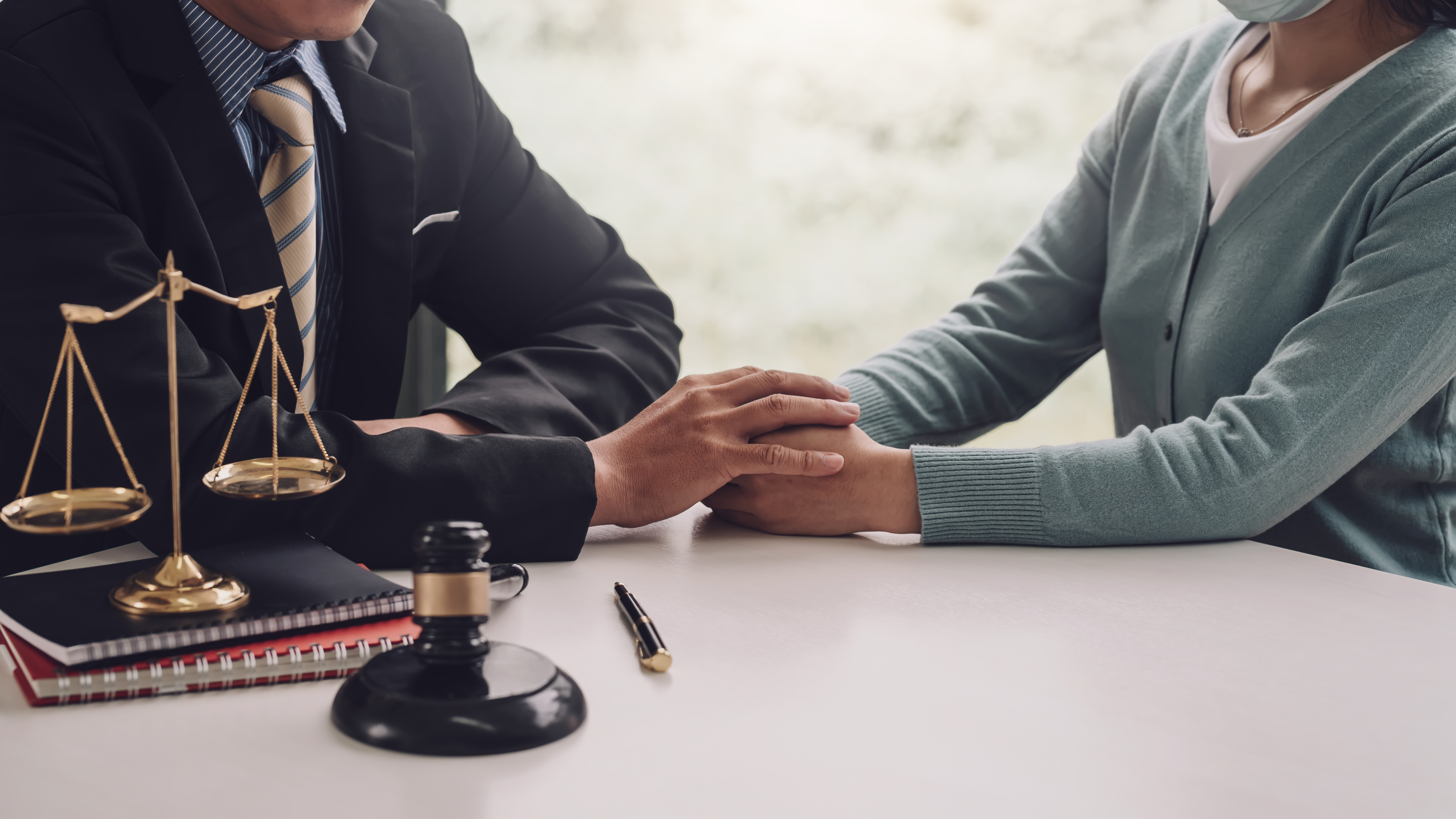 "Trust and Estate Planning: A lawyer and client seal the deal with a handshake in the office."