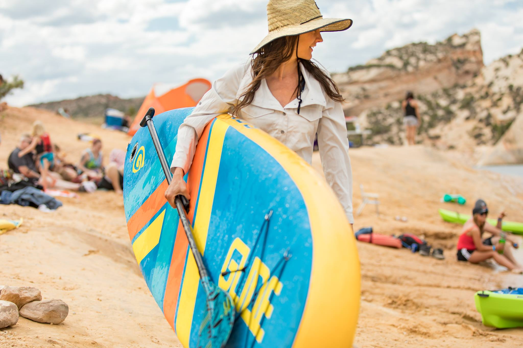 woman carrying an inflatable sup board