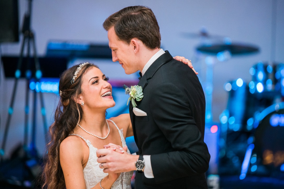 A wedding photographer capturing a couple's candid moments during a shoot.