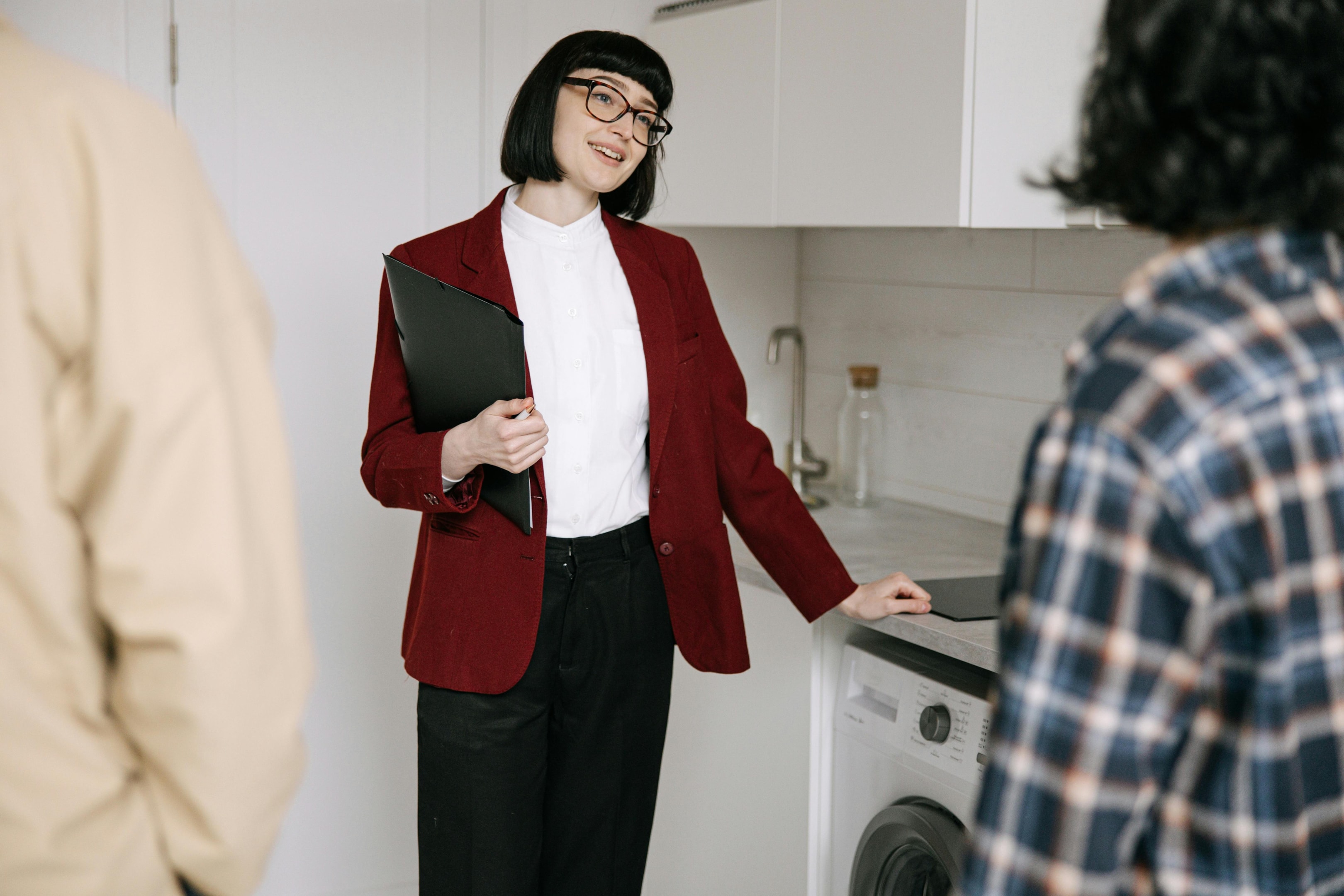 Real estate agent shows property to interested buyers. 