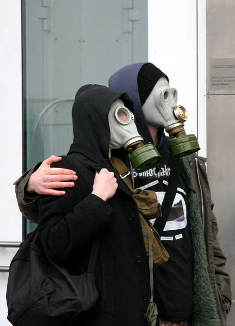 An image of two people wearing respirators outdoors.