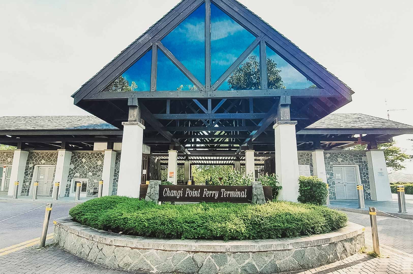 Main entrance of Changi Point Ferry Terminal featuring a pitched roof and landscaped greenery.