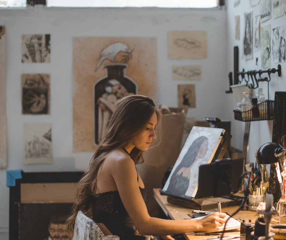 woman drawing a subject in her studio