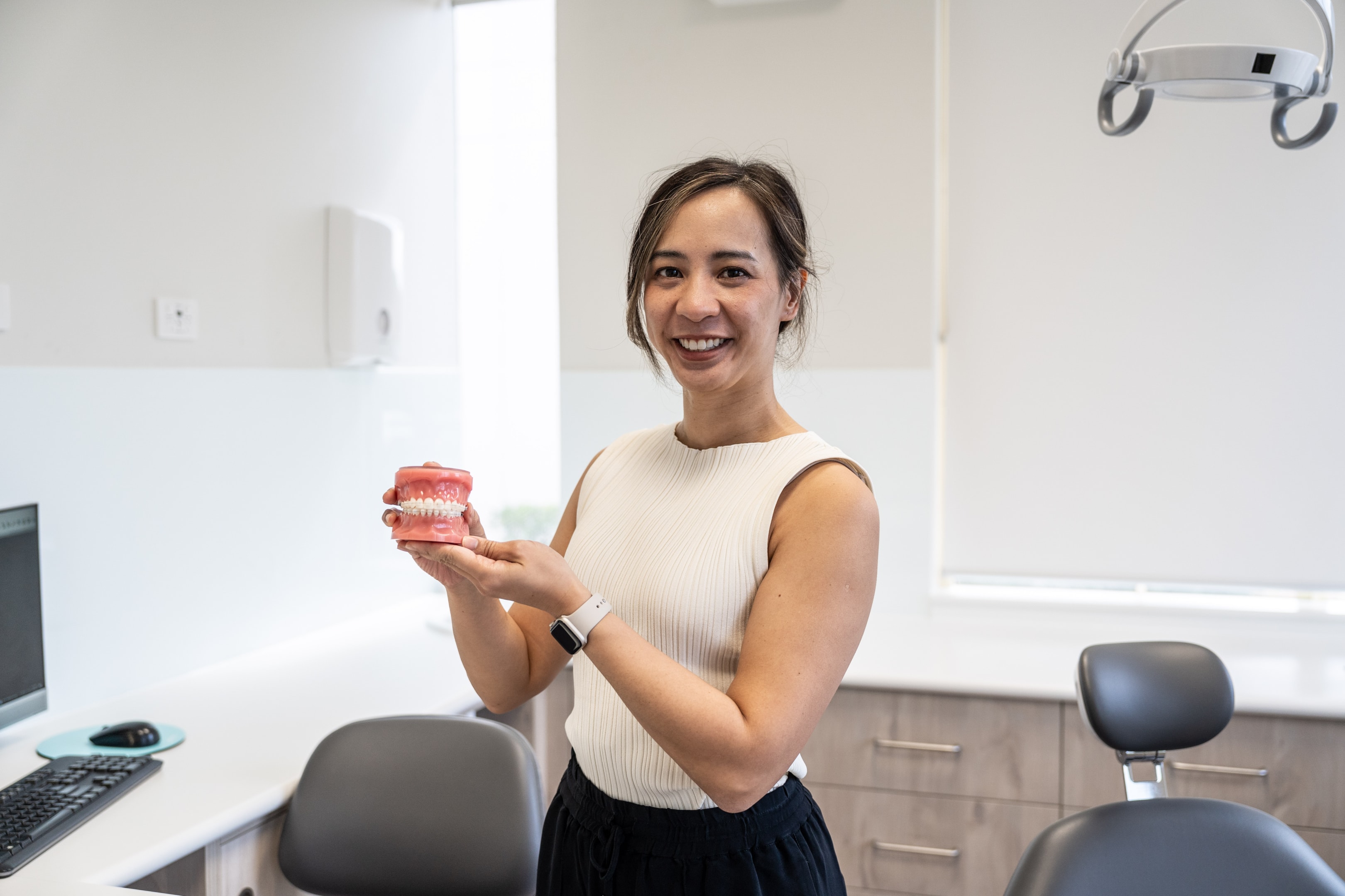 Orthodontist showing off ceramic braces