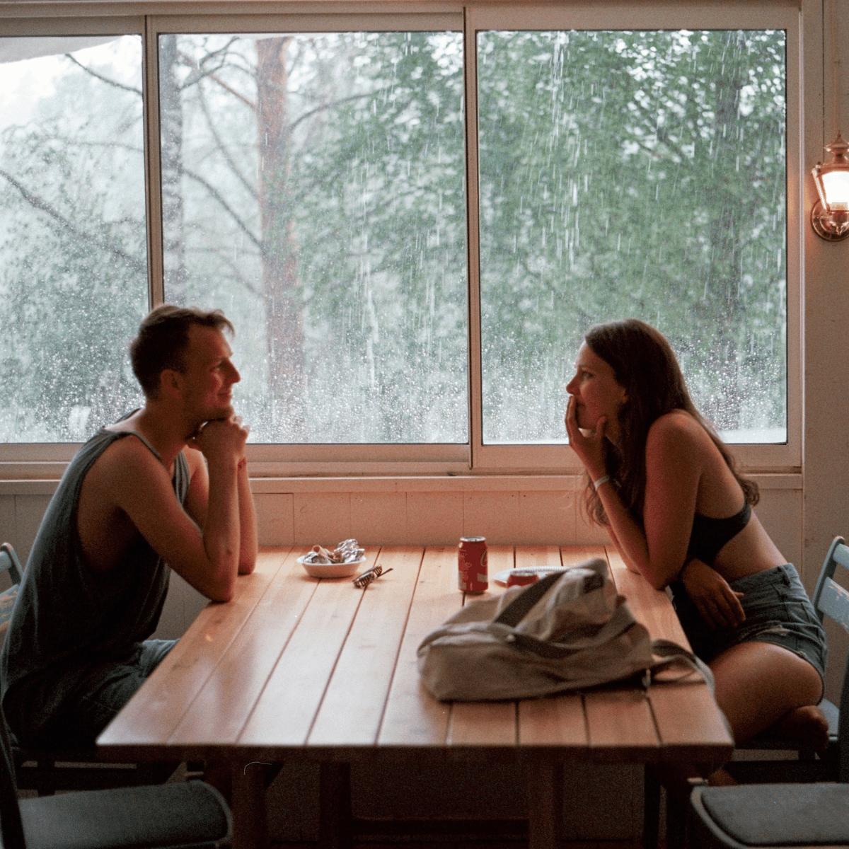 Coupel on a date, with rain in the background