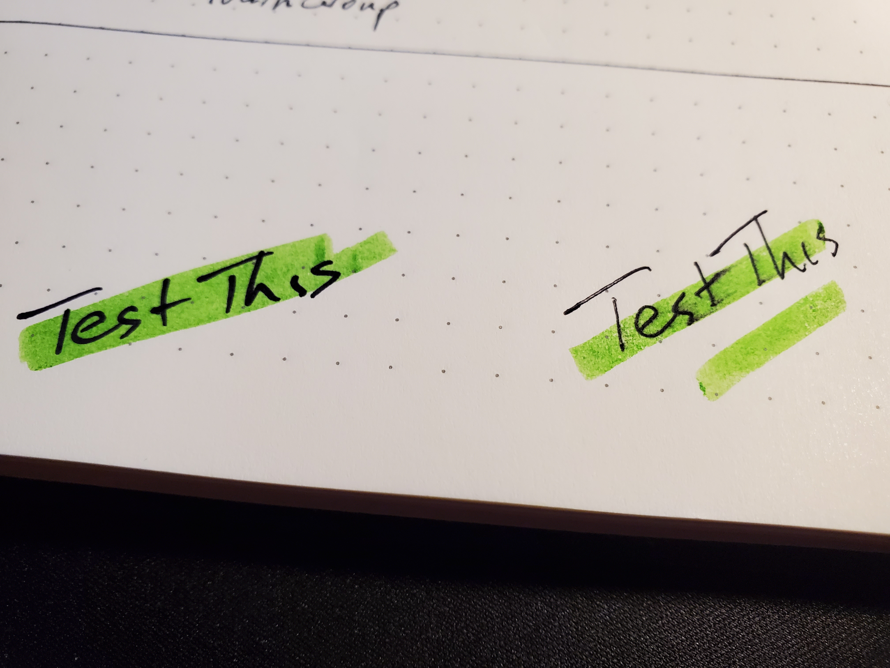 Comparing "Test This" written by permanent ink pen and a gel pen to show ink bleed from highlighter in bullet journal