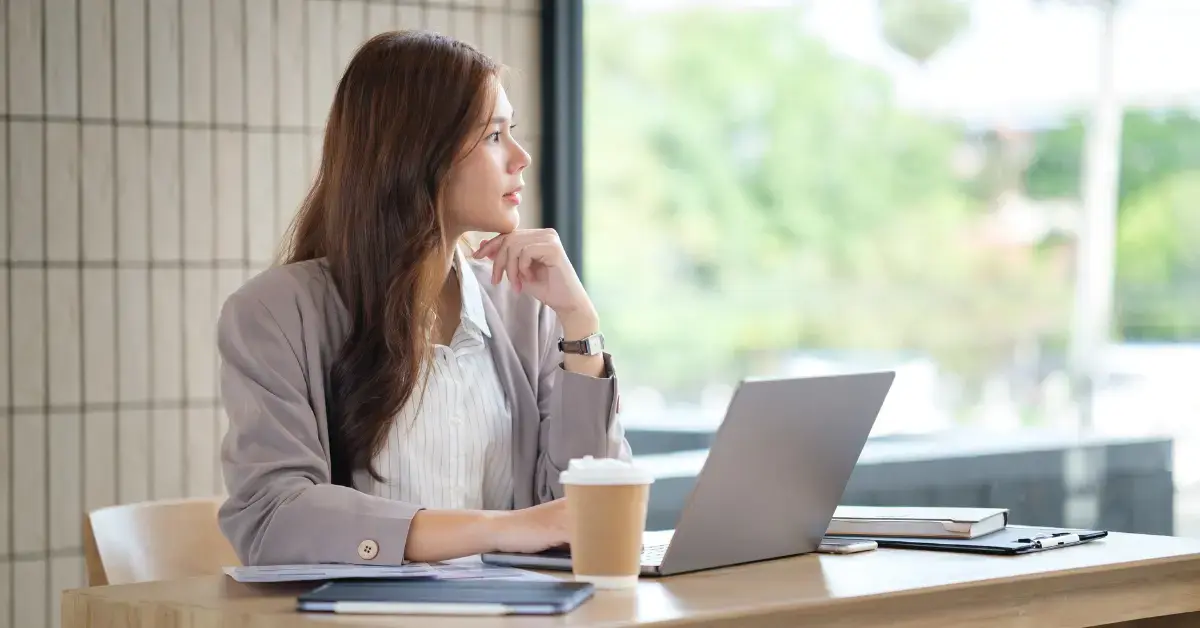 Woman reviewing a partial payment installment agreement and monthly IRS tax payments at her desk.