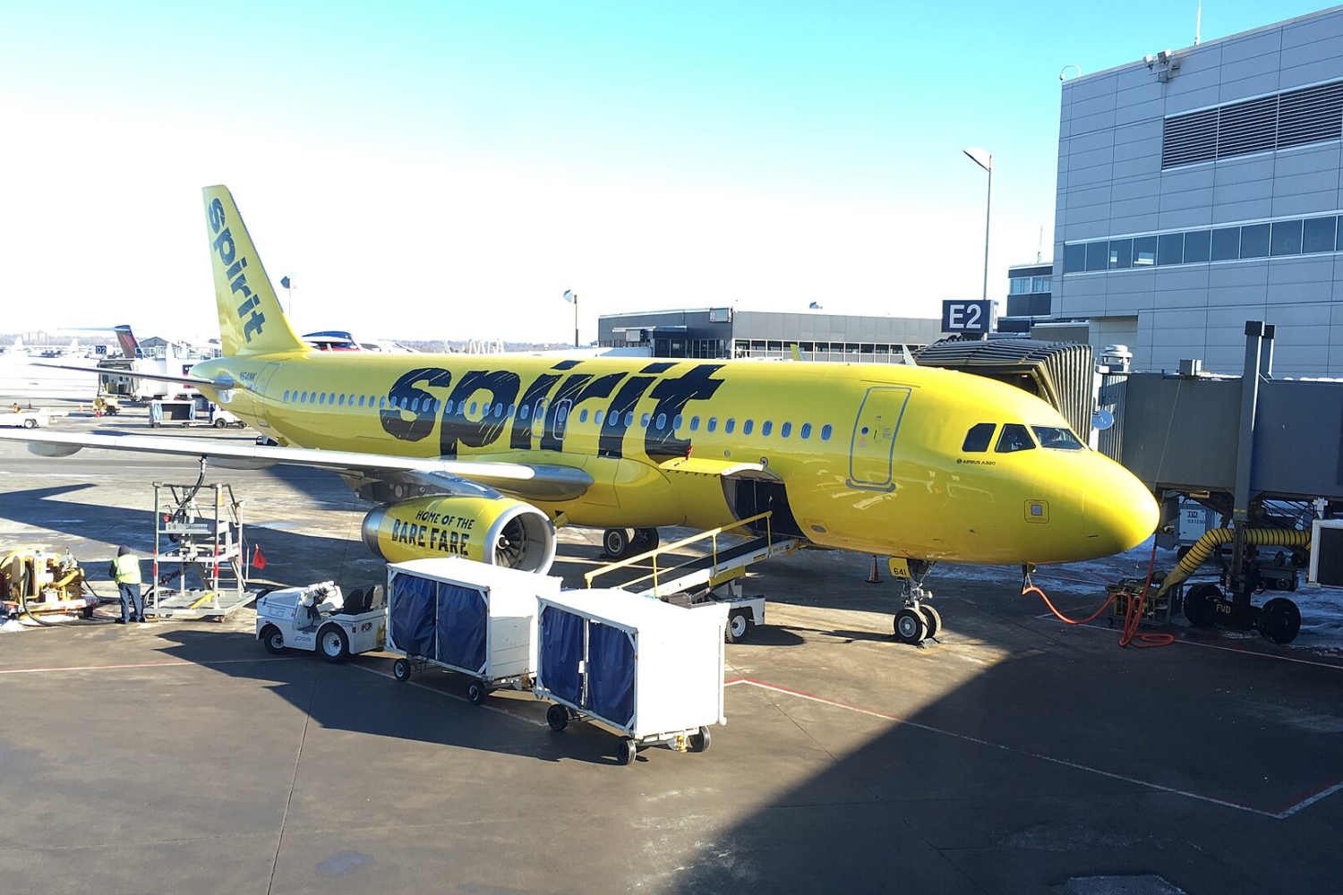 a spirit airlines flight at the airport. passengers can get Involuntary Refund Spirit Airlines