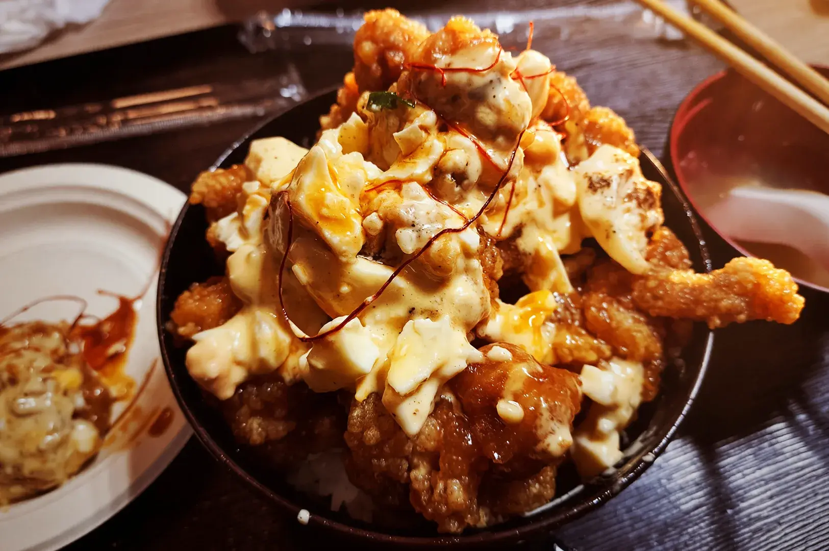 Close-up of a delicious Chicken Nanban rice bowl topped with creamy tartar sauce, served at Sakedoro Eizaburo, Fortune Centre.
