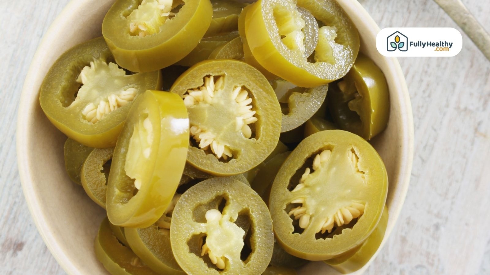 Bowl of sliced pickled jalapeños showing seeds