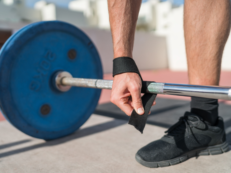 An image showing lifting straps wrapped around a barbell.