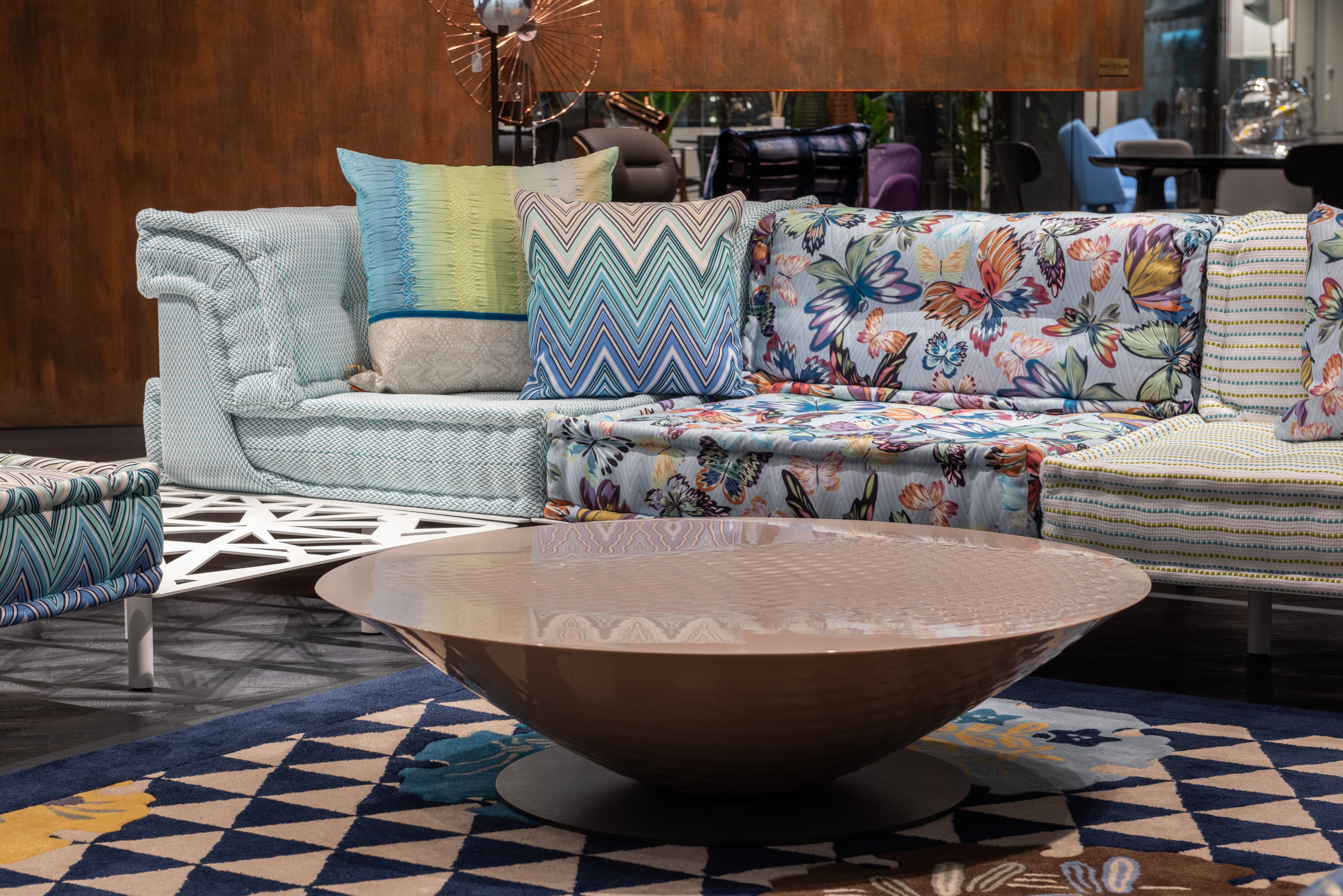 sofa with different patterned prints and round coffee table