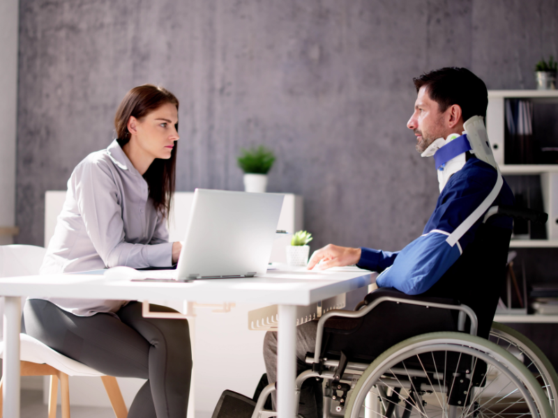 Image of a Georgia car accident lawyer helping a client with a settlement claim.