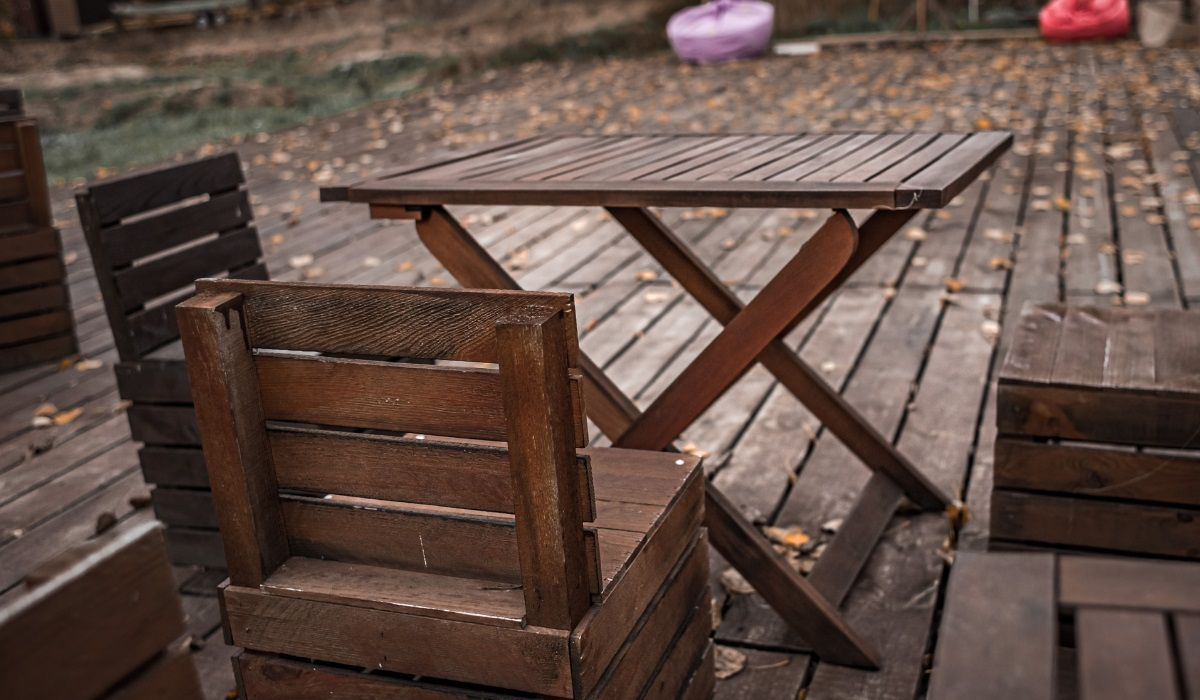Hardwood furniture - weathered garden furniture on decking