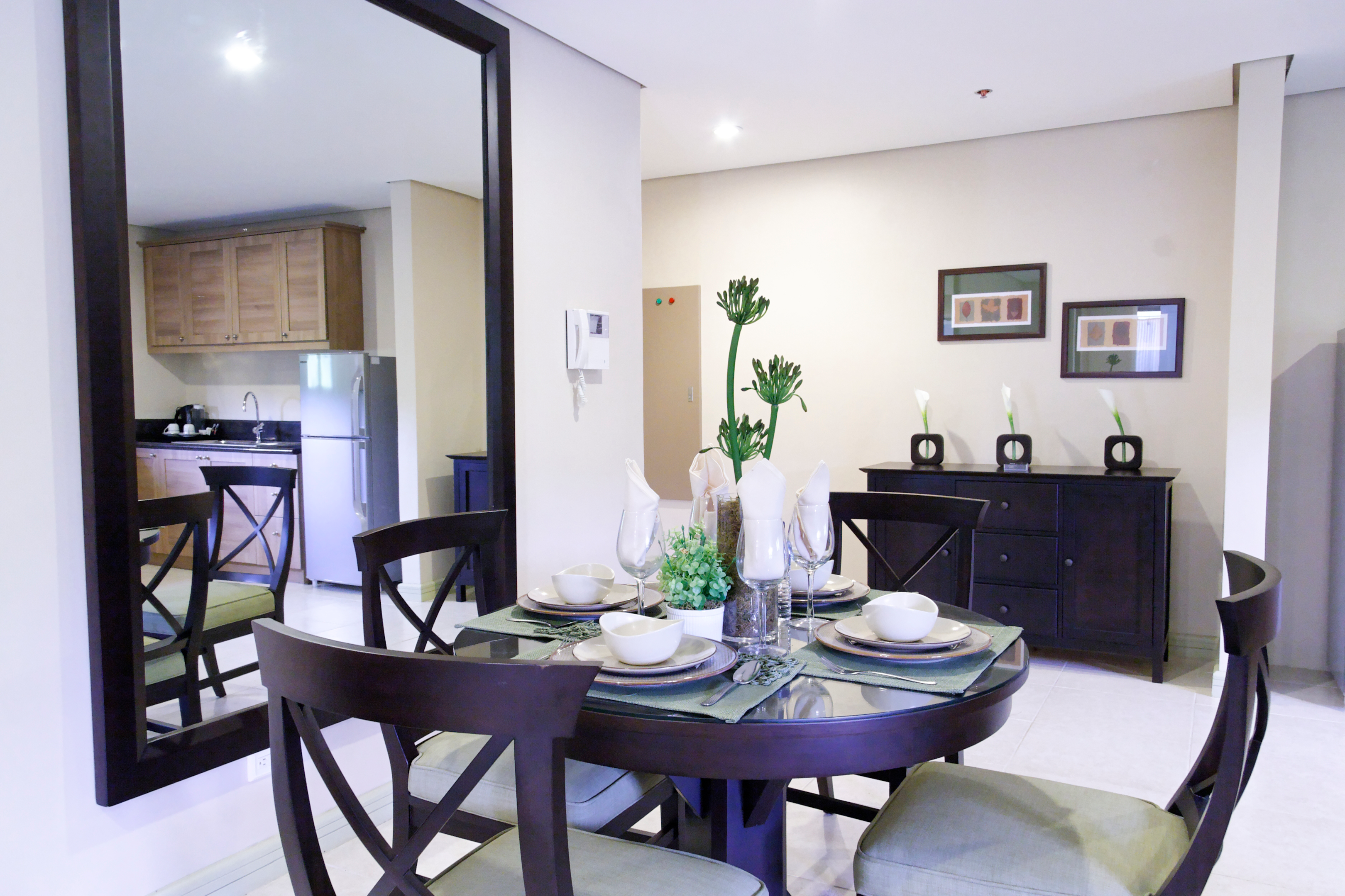Image of the dining area with glass mirror in front of the dining table | one bedroom unit rfo condo in tagaytay