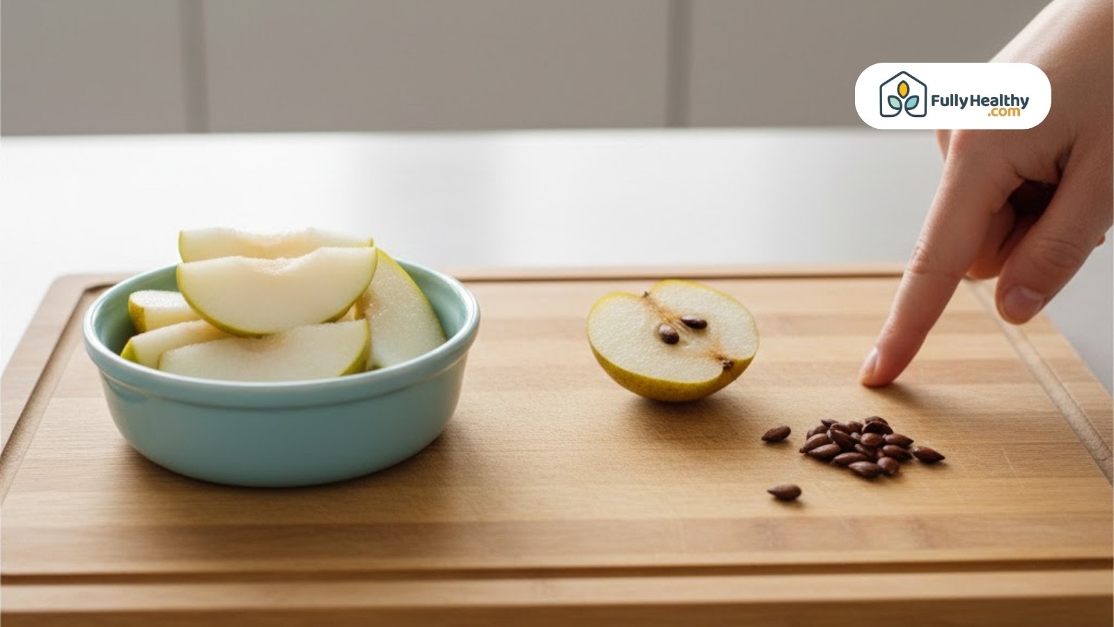 Pear slices in bowl with seeds separated on wooden board