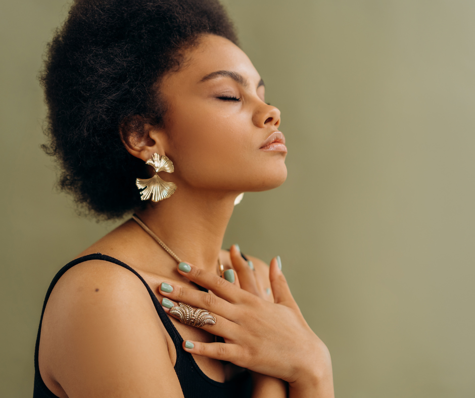 a woman deep breathing with hands on her chest