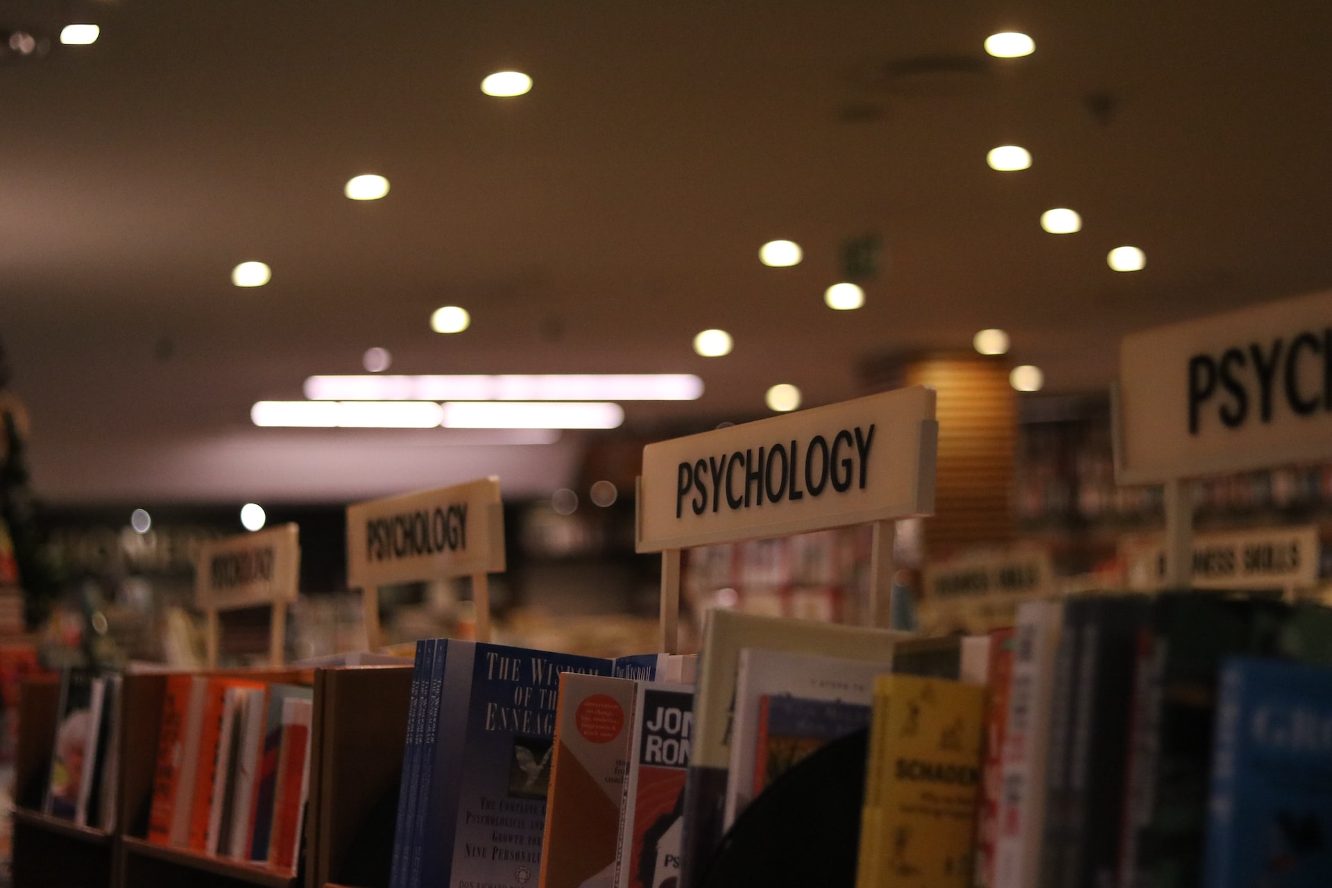 Psychology books on a shelf to become an aviation psychologist.