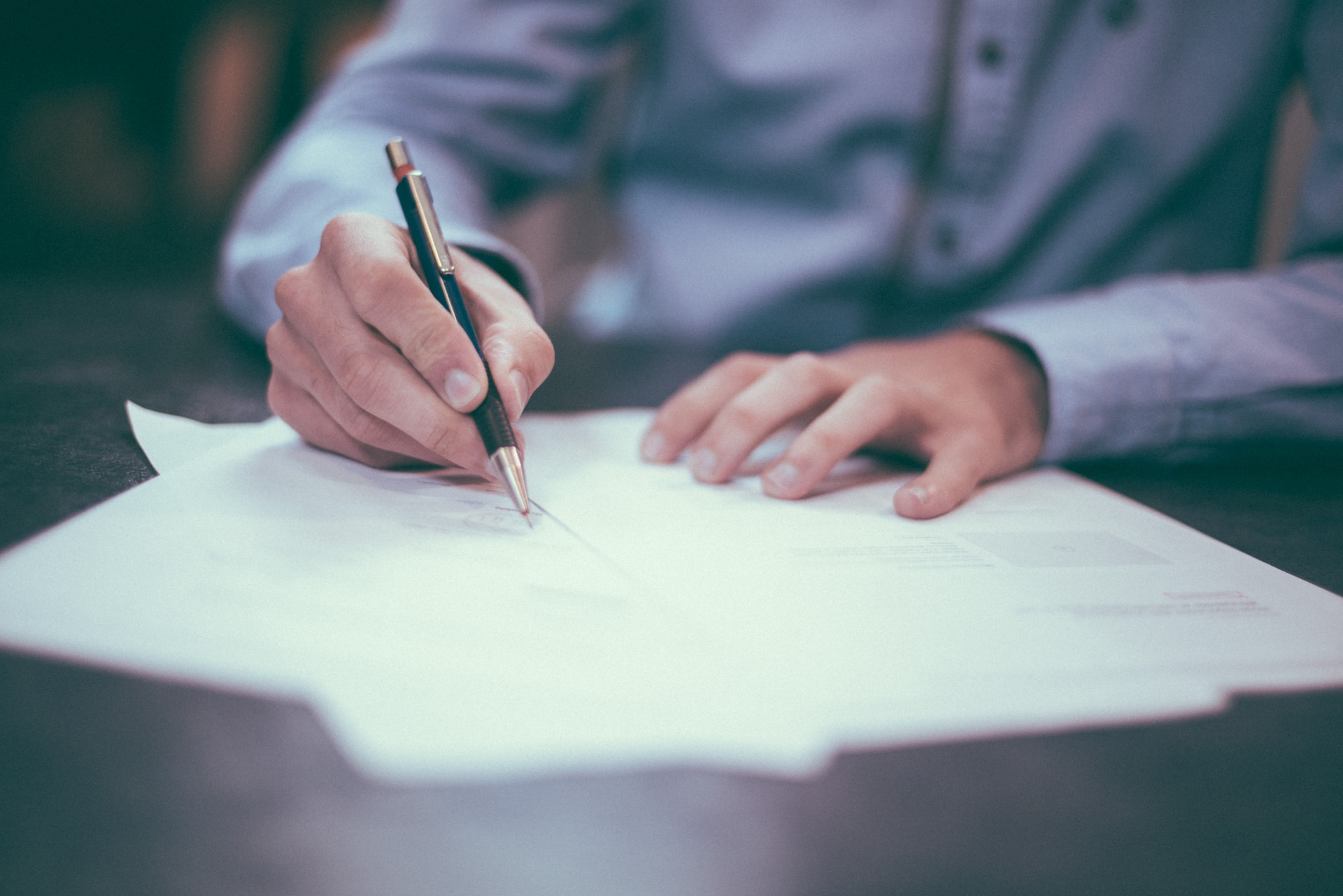 Person writing on a paper