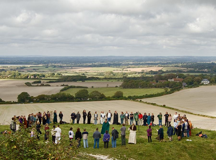 A circle closing beneath the Long Man (Windover Hill, Sussex Downs) in celebration of the 2007 Mabon autumn equinox festival. (Photo: Flickr/Chris Beckett)