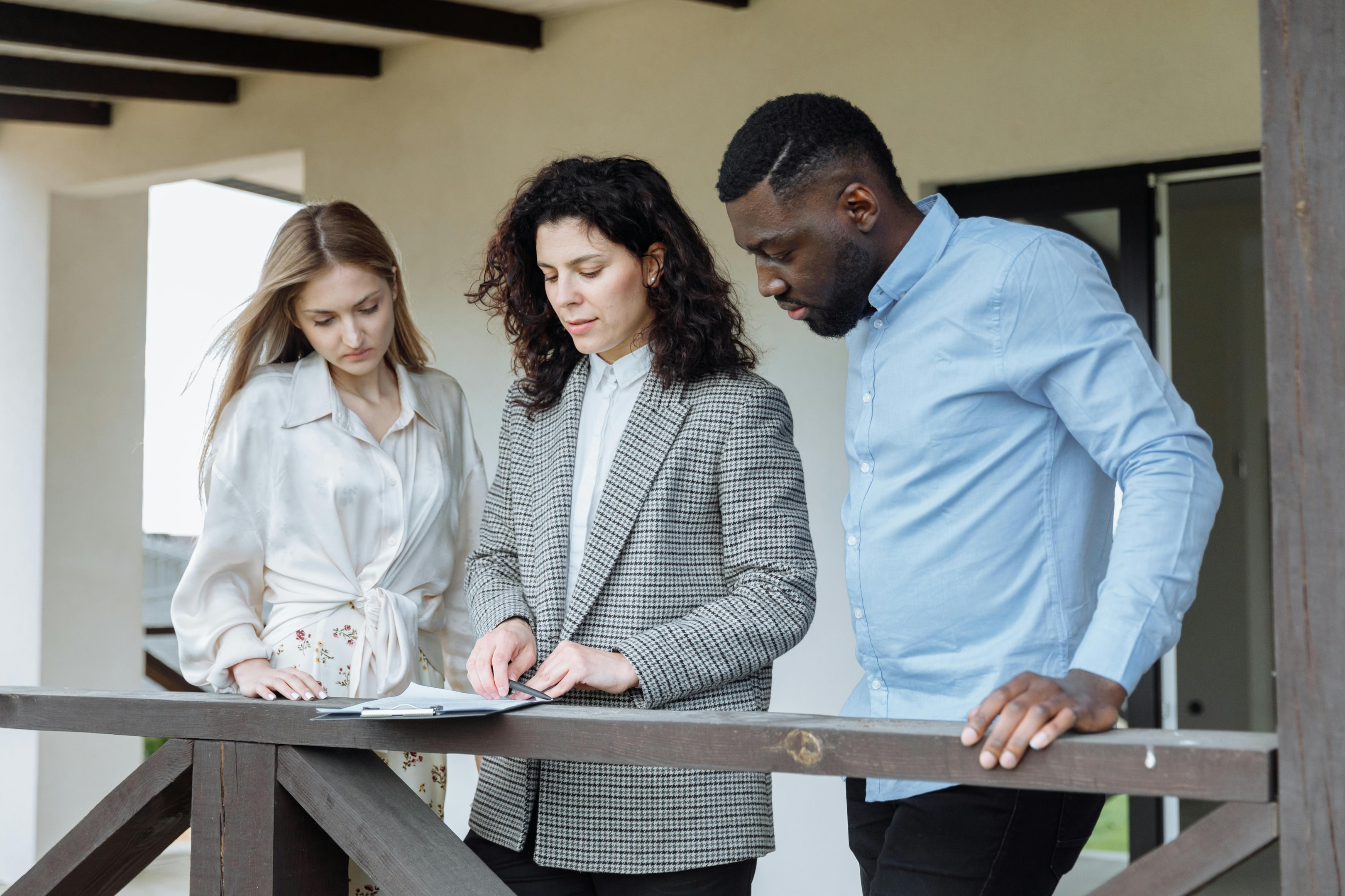 Real estate investor reviews property valuation information with home sellers.