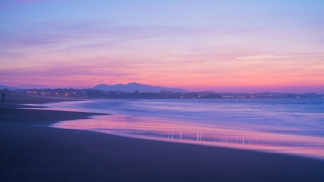 A sunset beach in New Zealand showcasing the inspiring landscape.